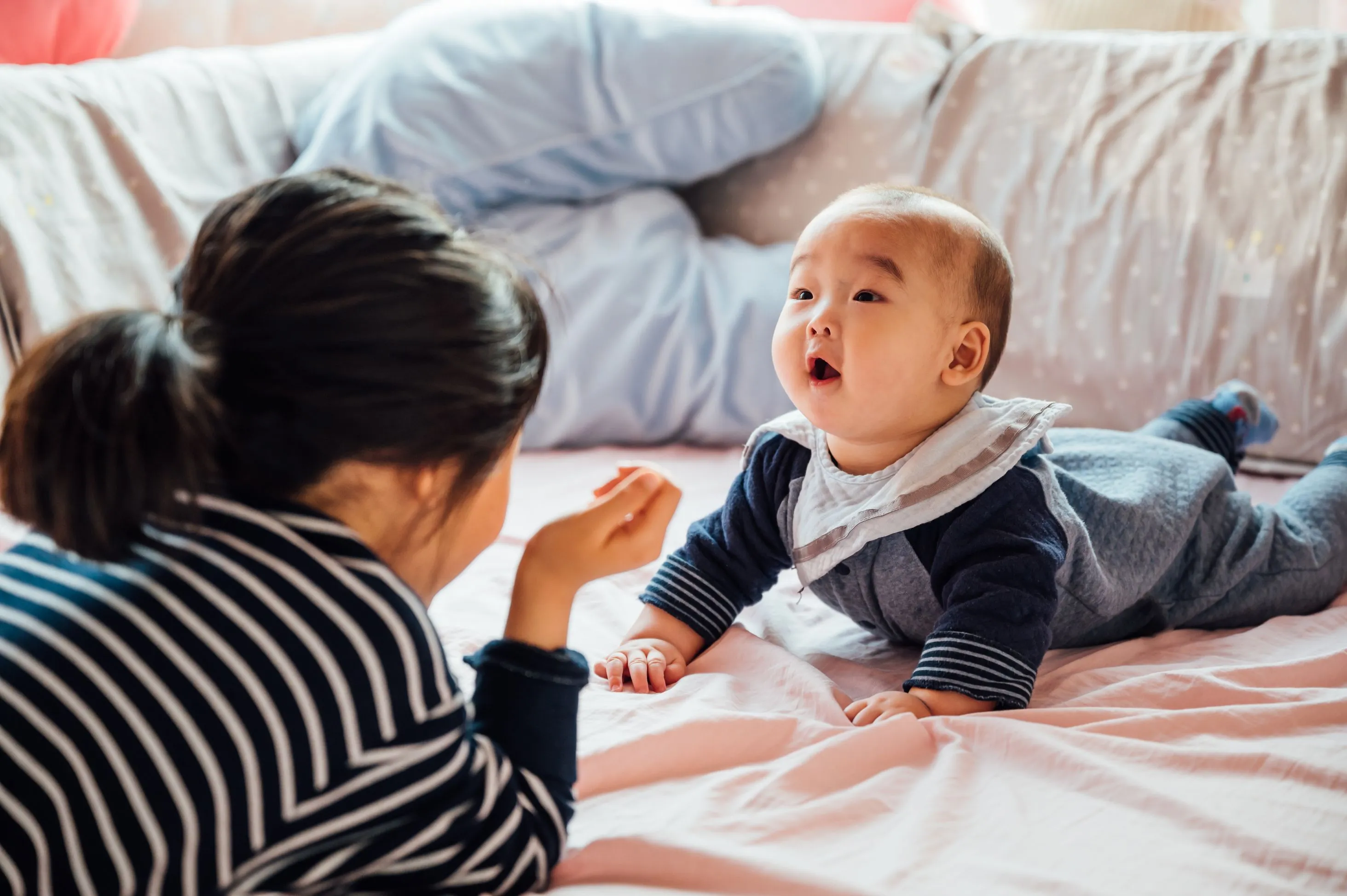 Girl playing with baby sibling at home